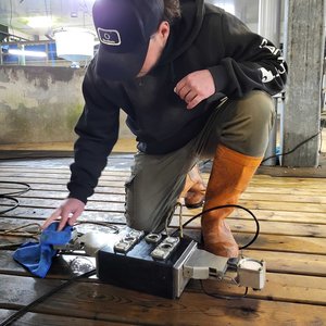 ReelData engineer cleaning the ReelBiomass camera lenses