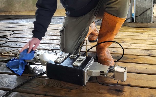 ReelData engineer cleaning the ReelBiomass camera lenses